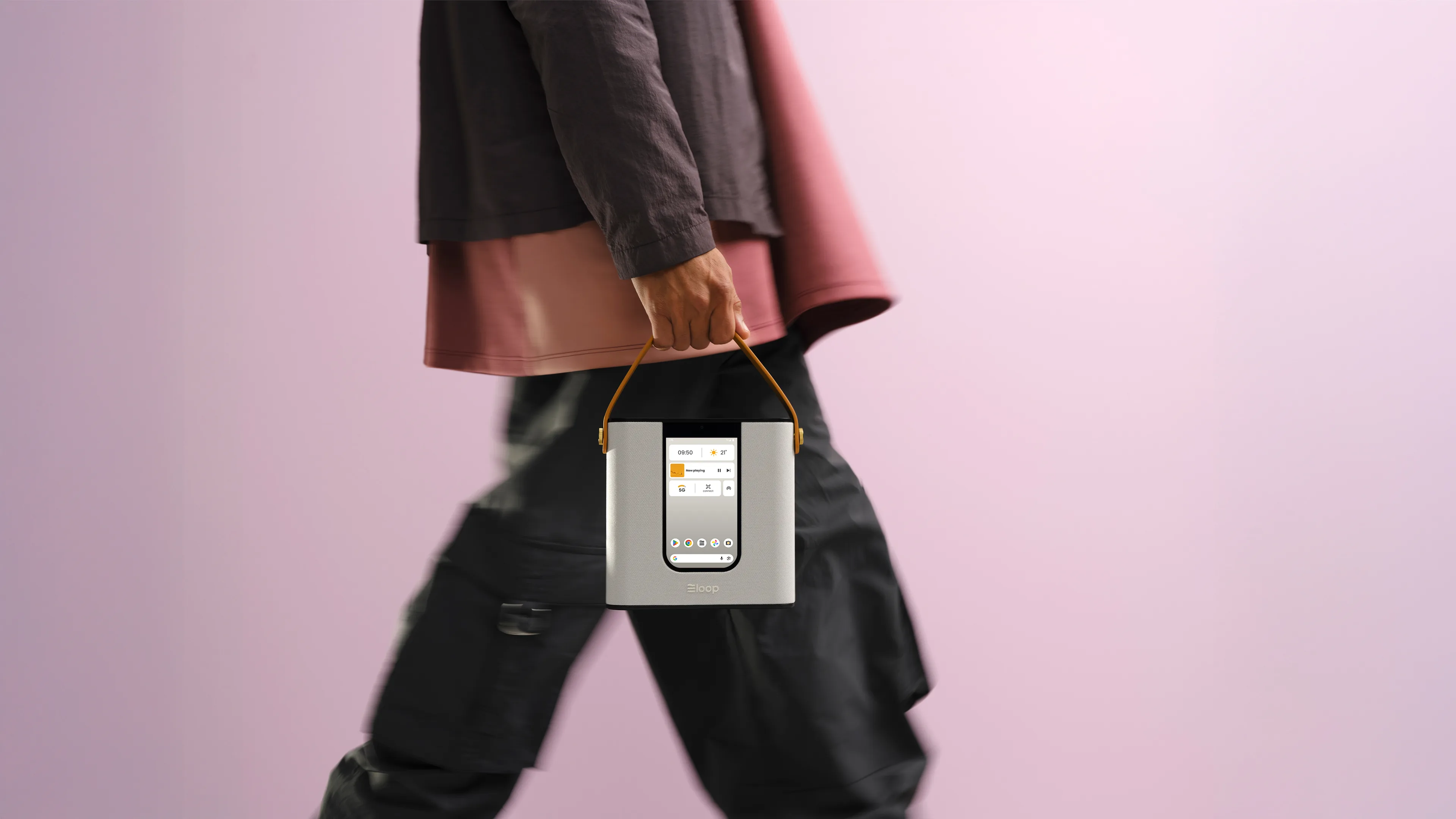 Someone walking with a grey loop, carried by its tan handle