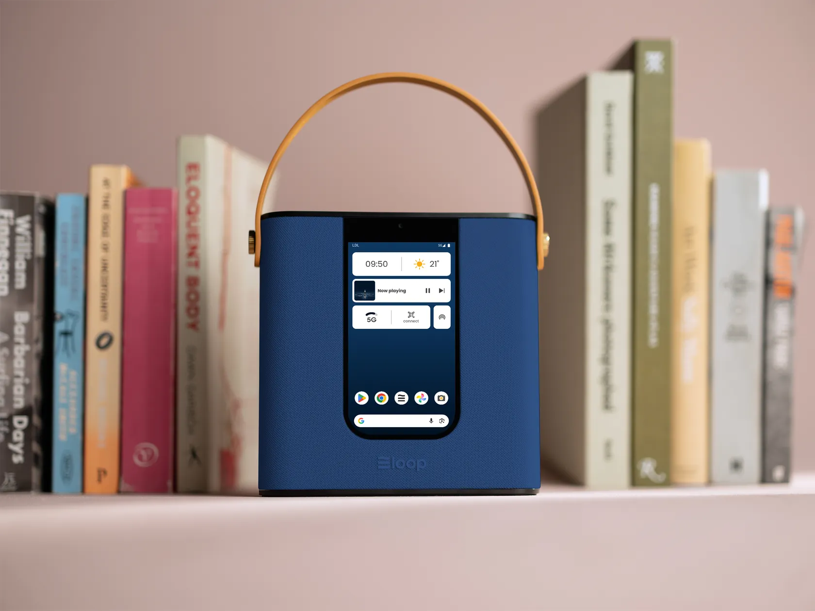 loopTwo in blue on a bookshelf, its home screen lit